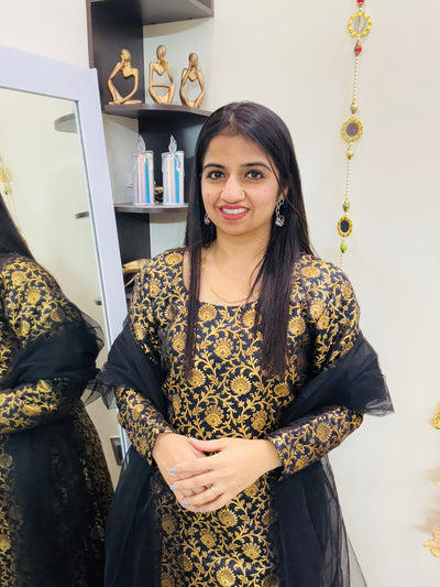Black and golden brocade suit set with matching pants and lace-detailed net dupatta – festive ethnic wear for women